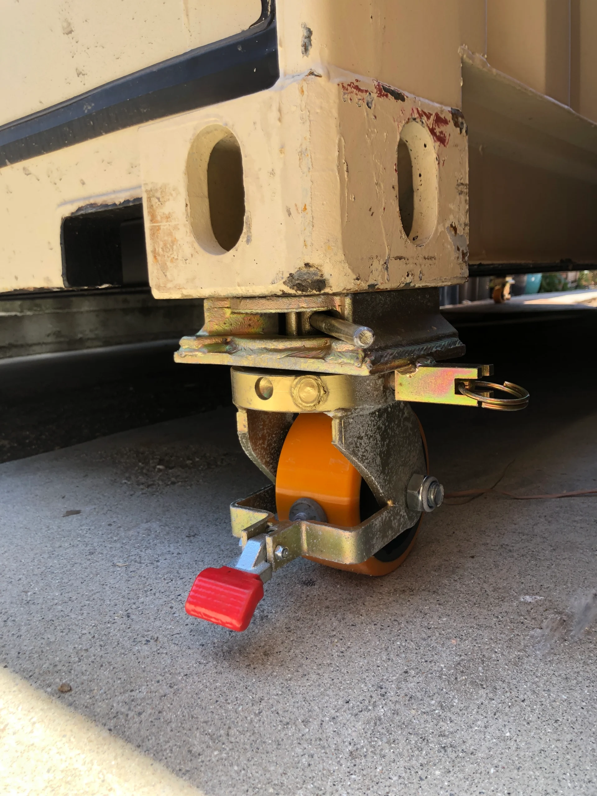 Twistlock Dynamics Compact casters supporting a shipping container on outdoor terrain.